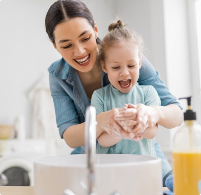 mother and daughter washing hands