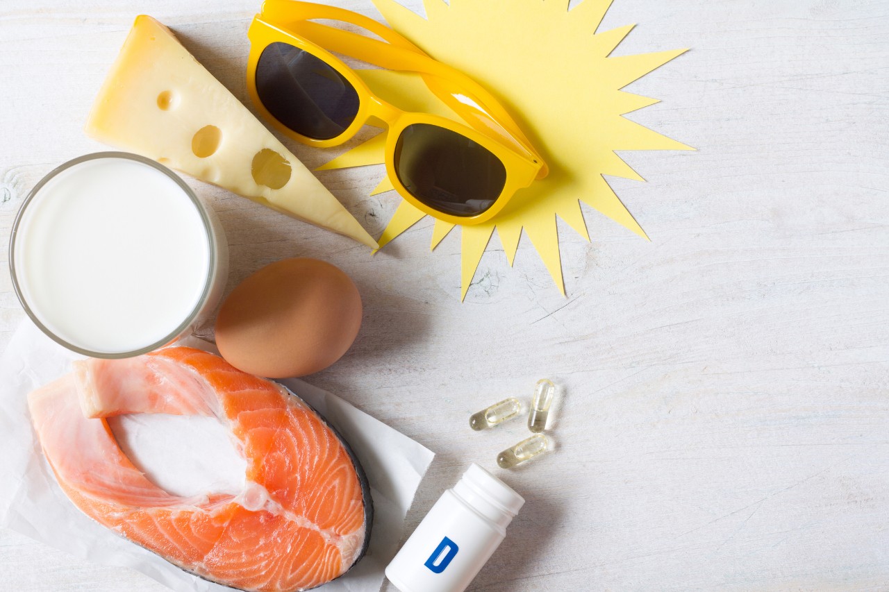 Food products, sun and vitamin D in capsules, various sources of vitamin D concept background