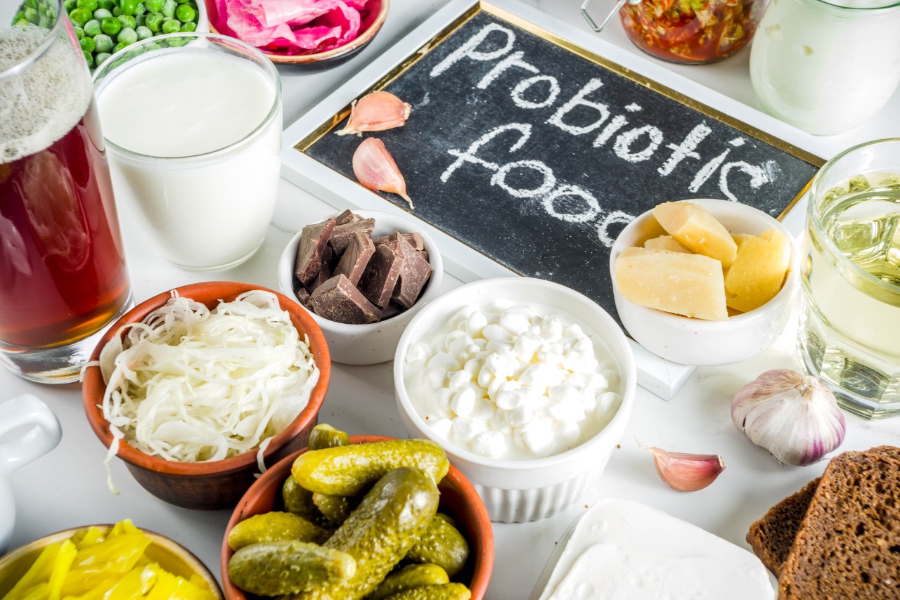 Super Healthy Probiotic Fermented Food Sources, drinks, ingredients, on white marble background copy space top view
