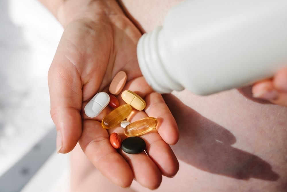 Different vitamins and supplements from a white pill bottle